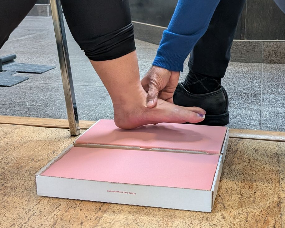 A man is wearing a posture corrector on his back.