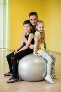 Women and Kids In Physical Therapy Class