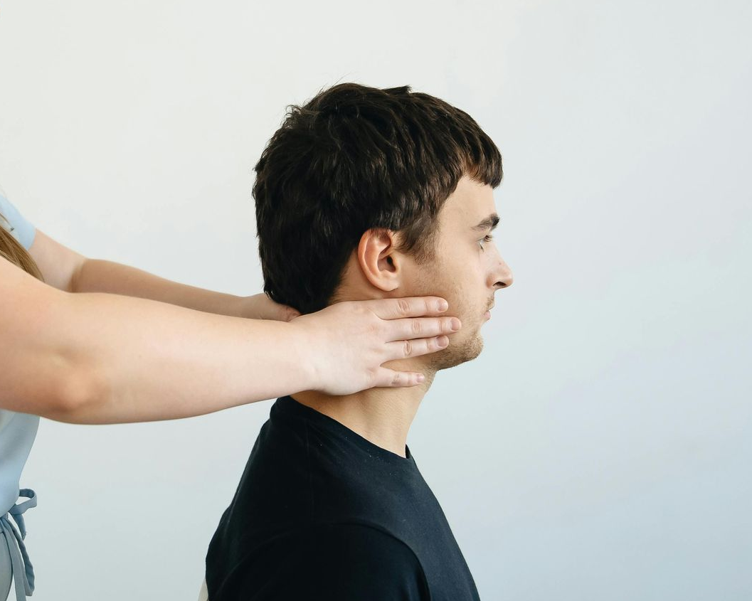 A woman is getting her wrist examined by a doctor.