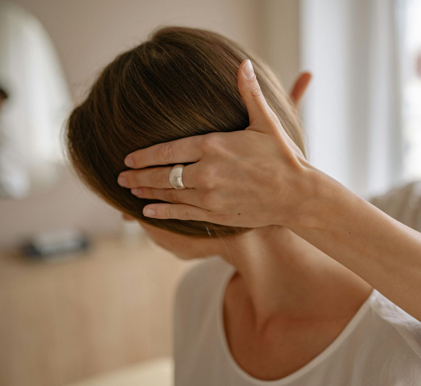 A man is wearing a posture corrector on his back.