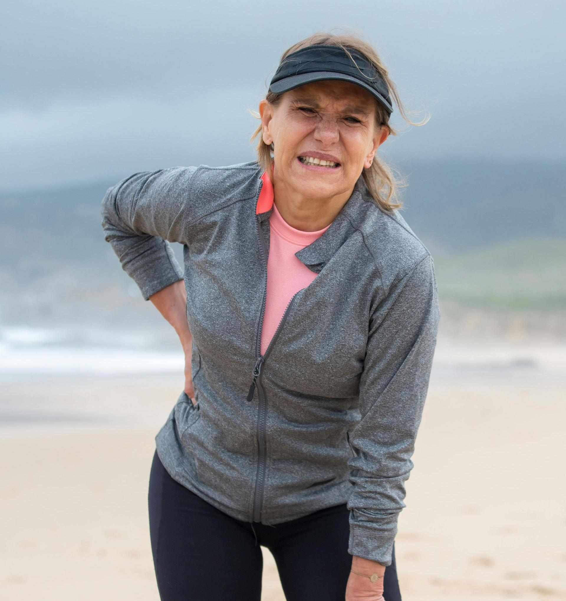 A man is wearing a posture corrector on his back.