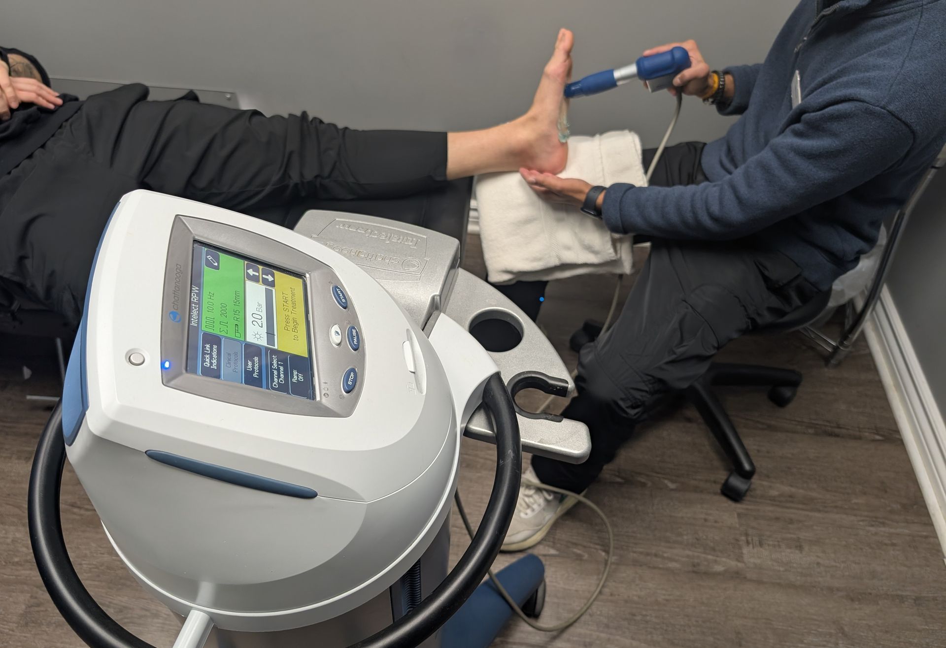 A woman is getting her wrist examined by a doctor.