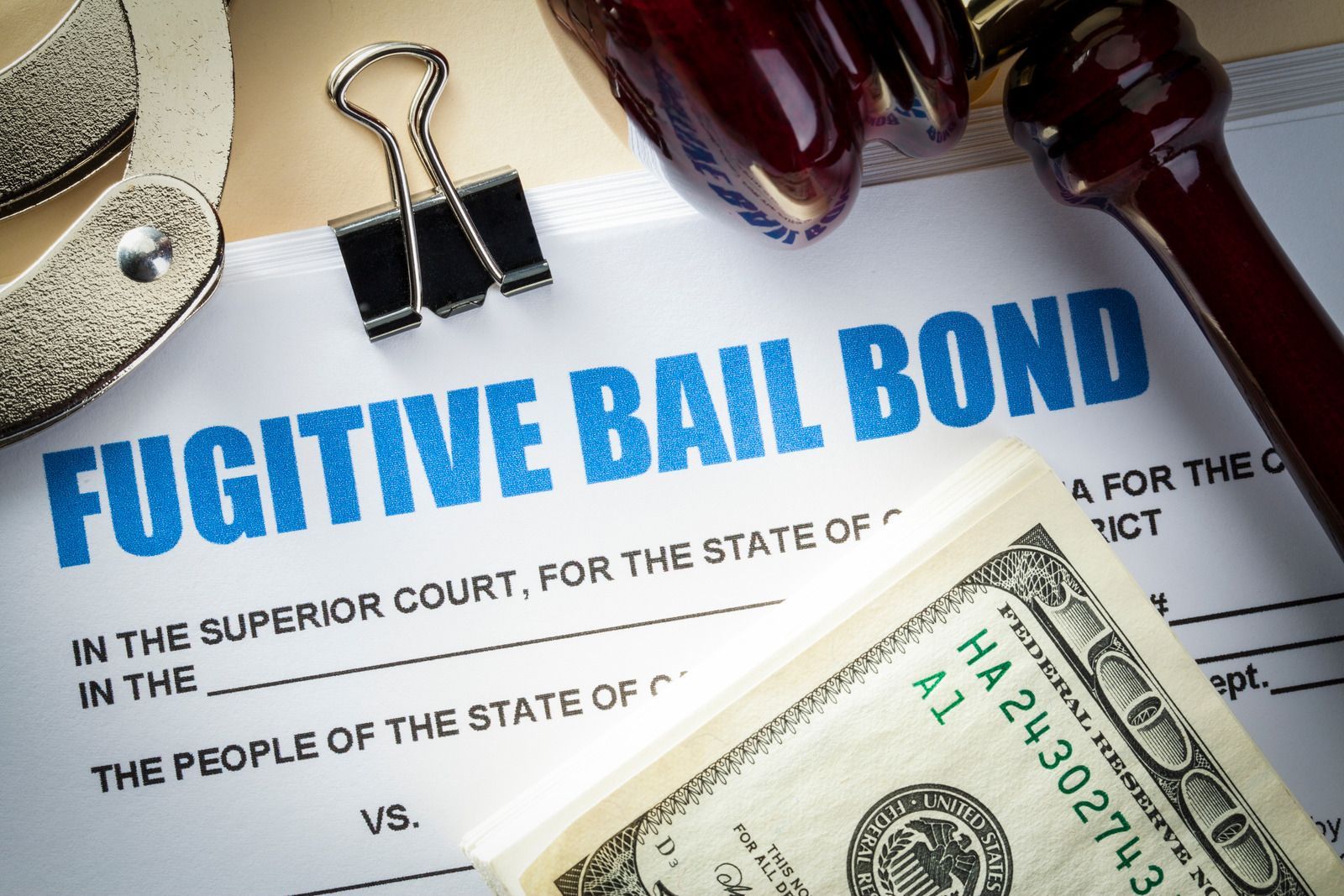 A fugitive bail bond with a dollar bill on top of it