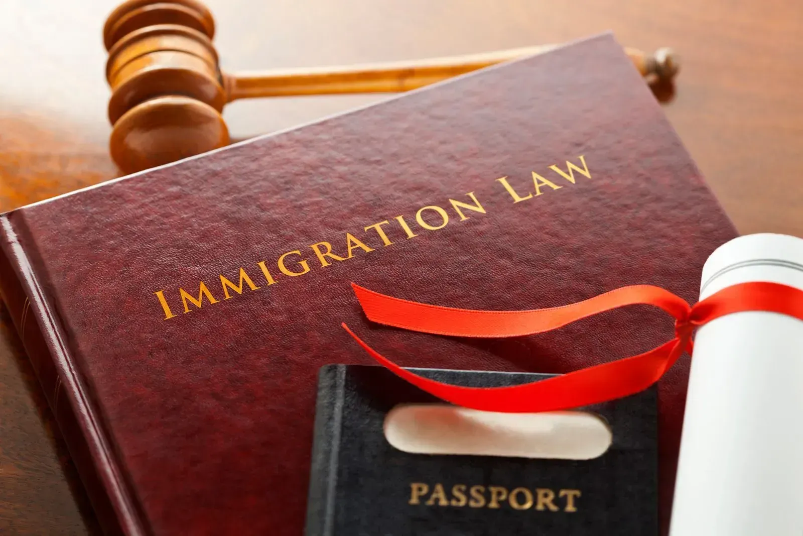 A book titled immigration law with a passport and a gavel