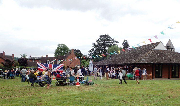 a wide shot of hampton bishop church fete in 2021 with villagers enjoing all the activities