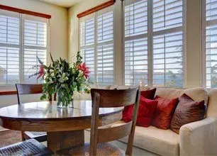 There is a vase of flowers on the table in the living room.