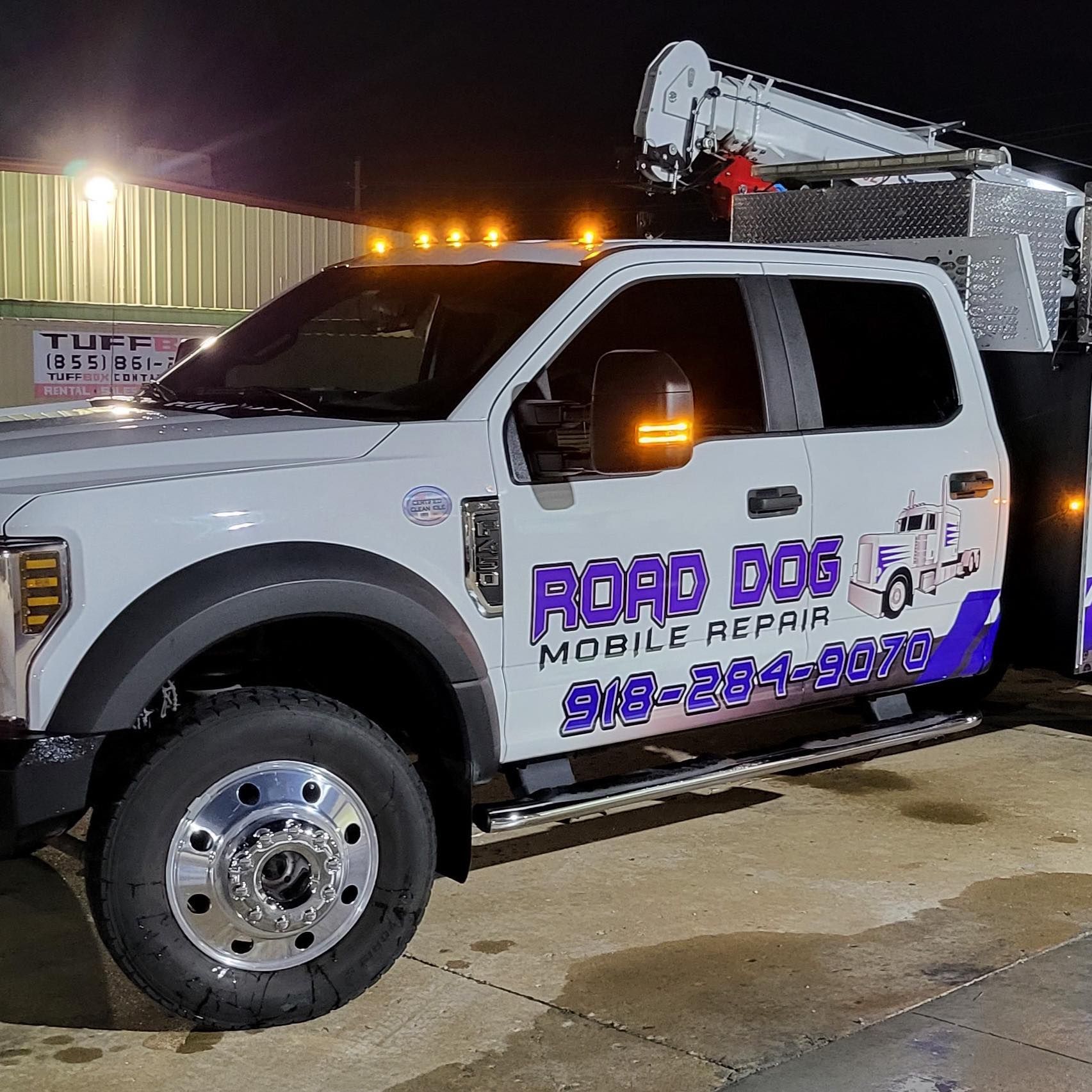 A white truck that says road edge mobile repair on the side