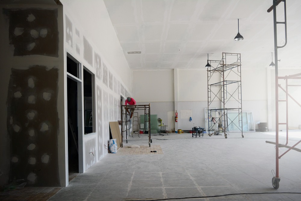 a large empty building under construction with scaffolding in the background .