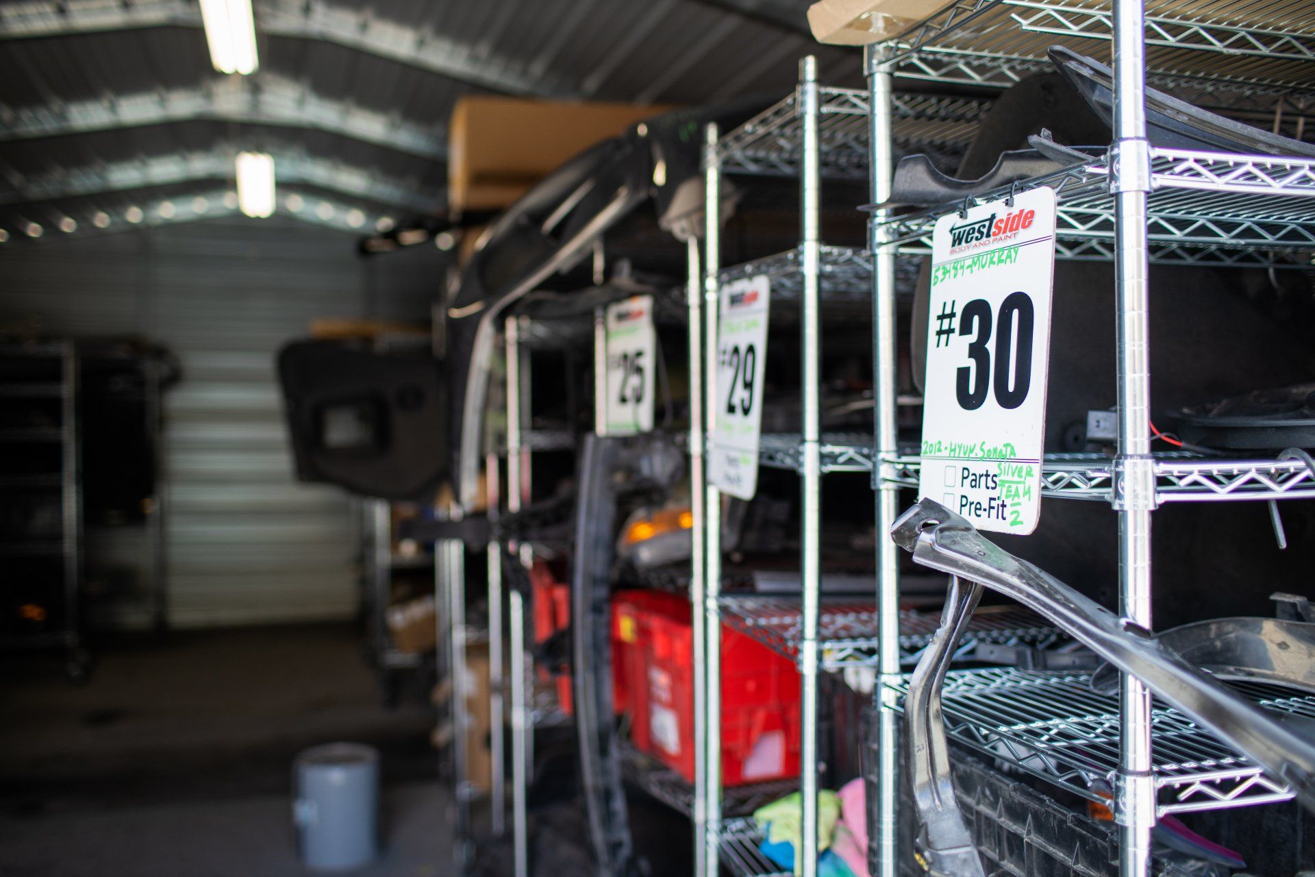 Westside Body and Paint parts and storage area with OEM and aftermarket auto parts.