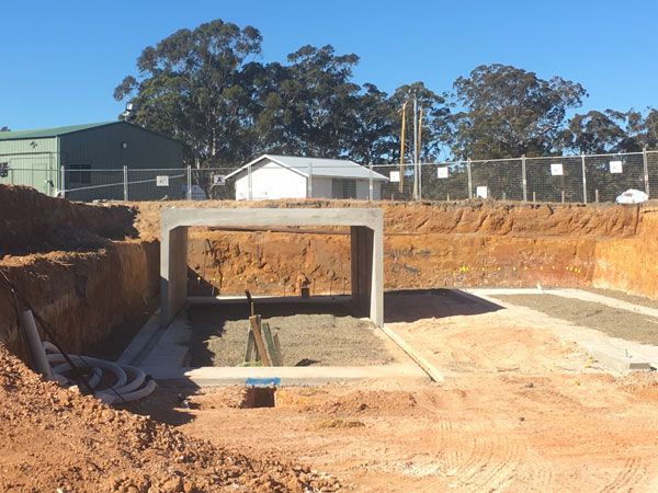 A construction site with a building in the background