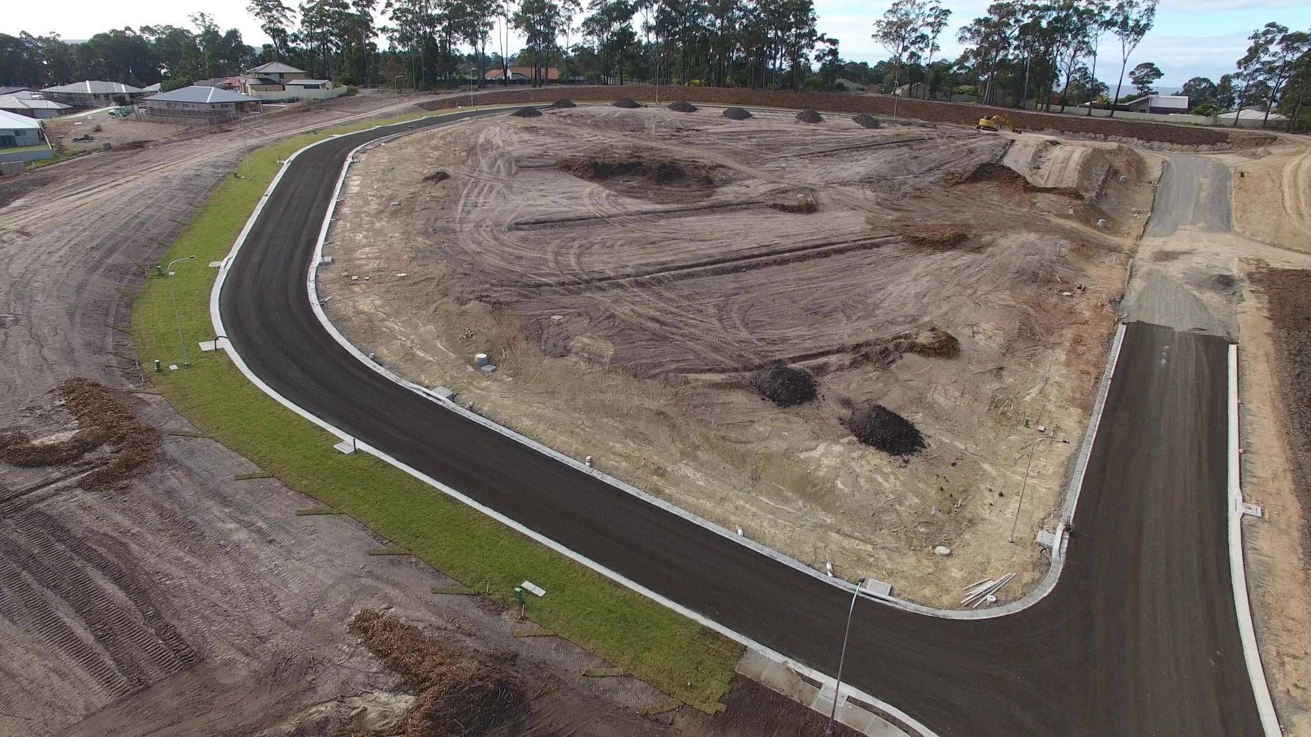 An aerial view of a curvy road in a residential area.