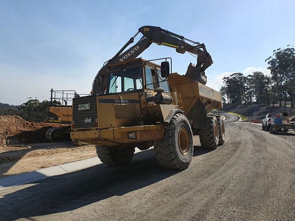A volvo dump truck is parked on the side of the road