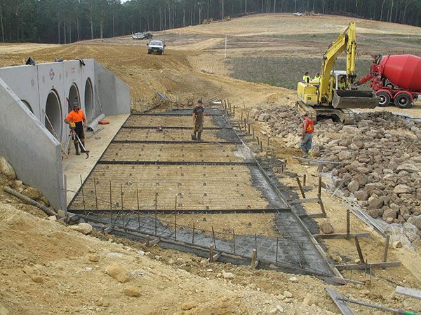 A construction site with a concrete mixer in the background