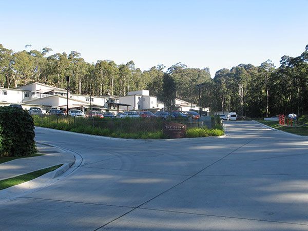 A residential area with a lot of cars parked on the side of the road