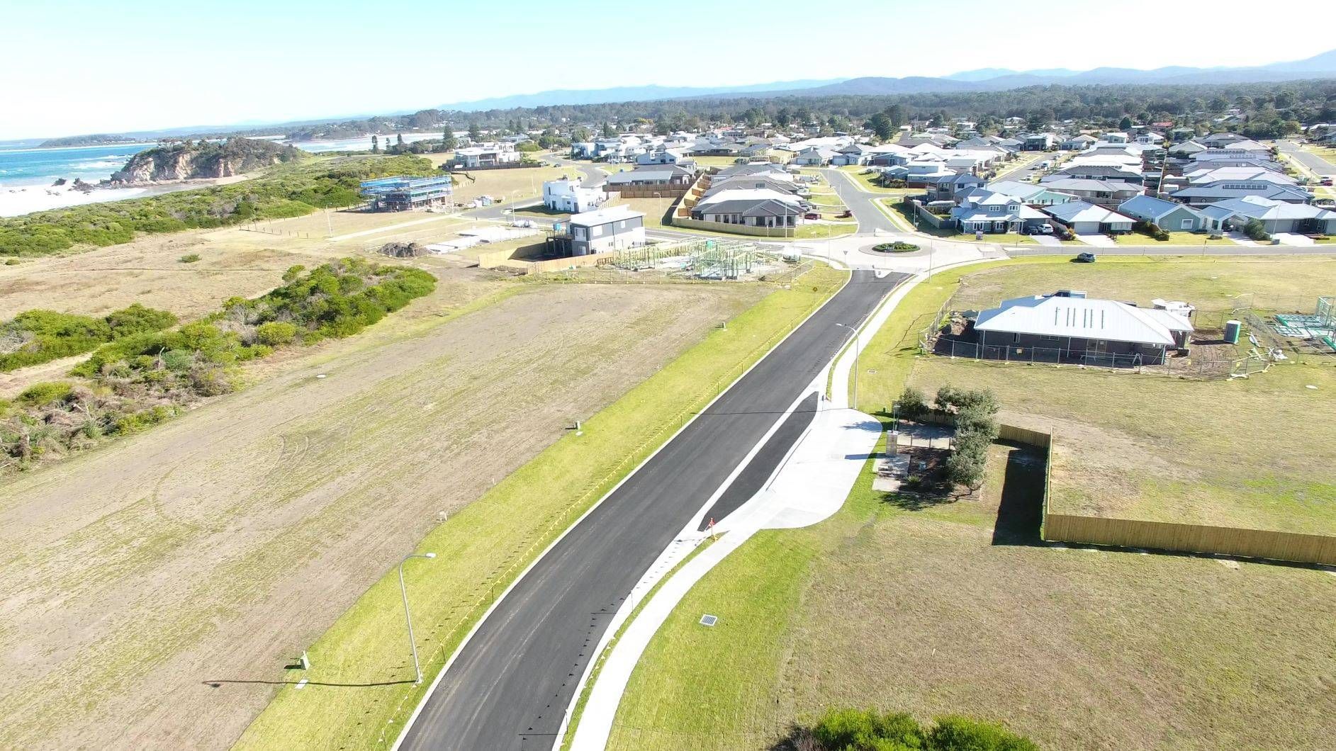 An aerial view of a road going through a residential area.
