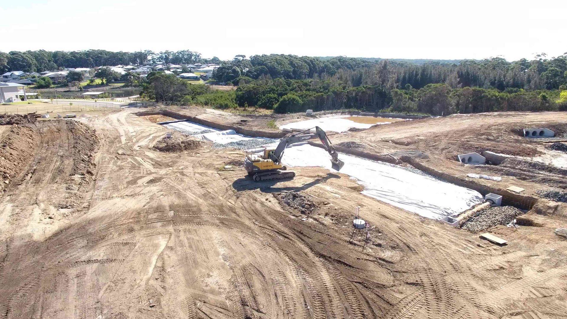 An aerial view of a construction site with a bulldozer moving dirt.