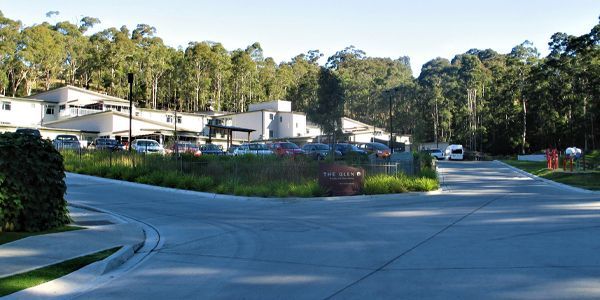 A residential area with a lot of cars parked on the side of the road.