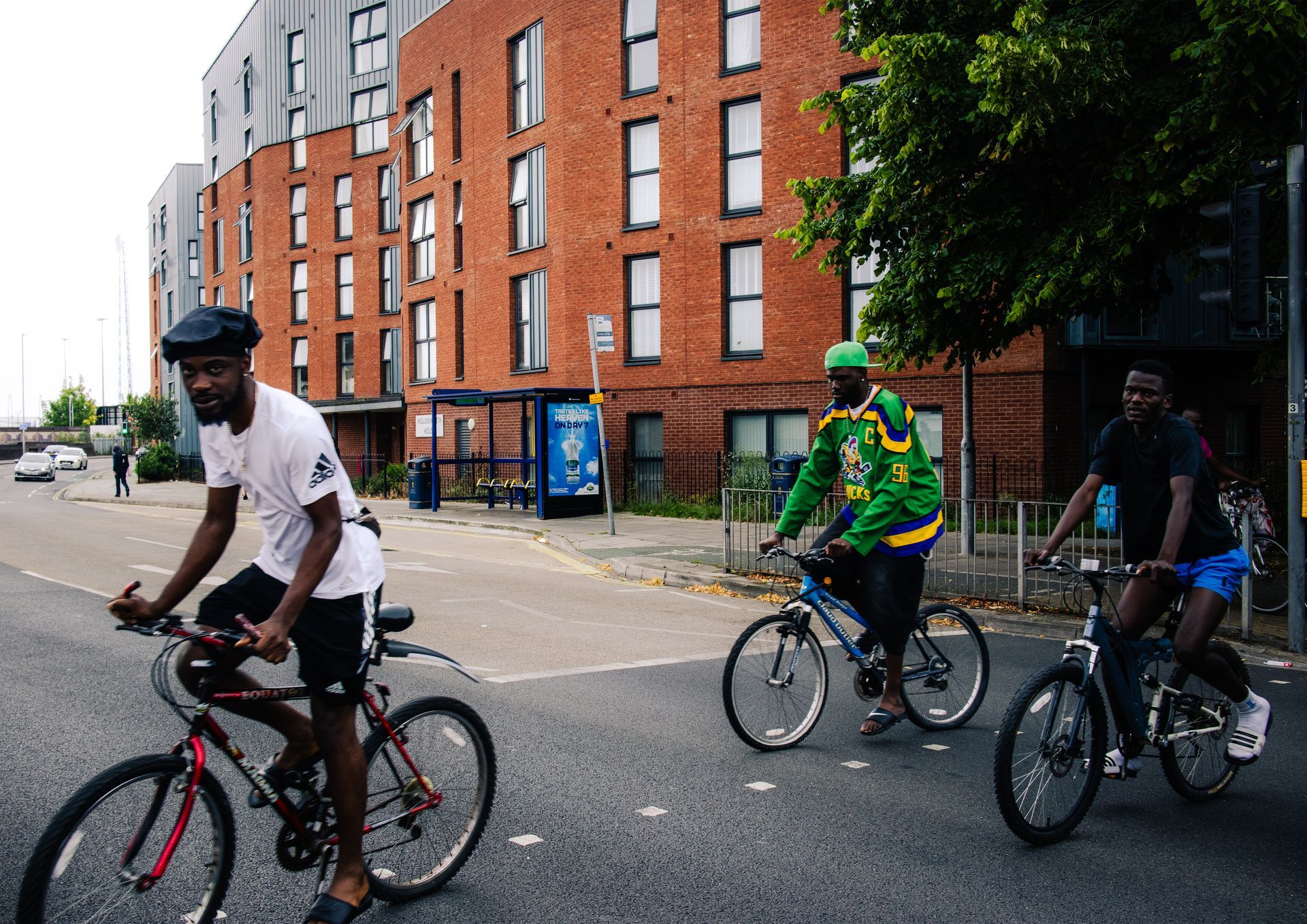 A group of people are riding bicycles down a street.