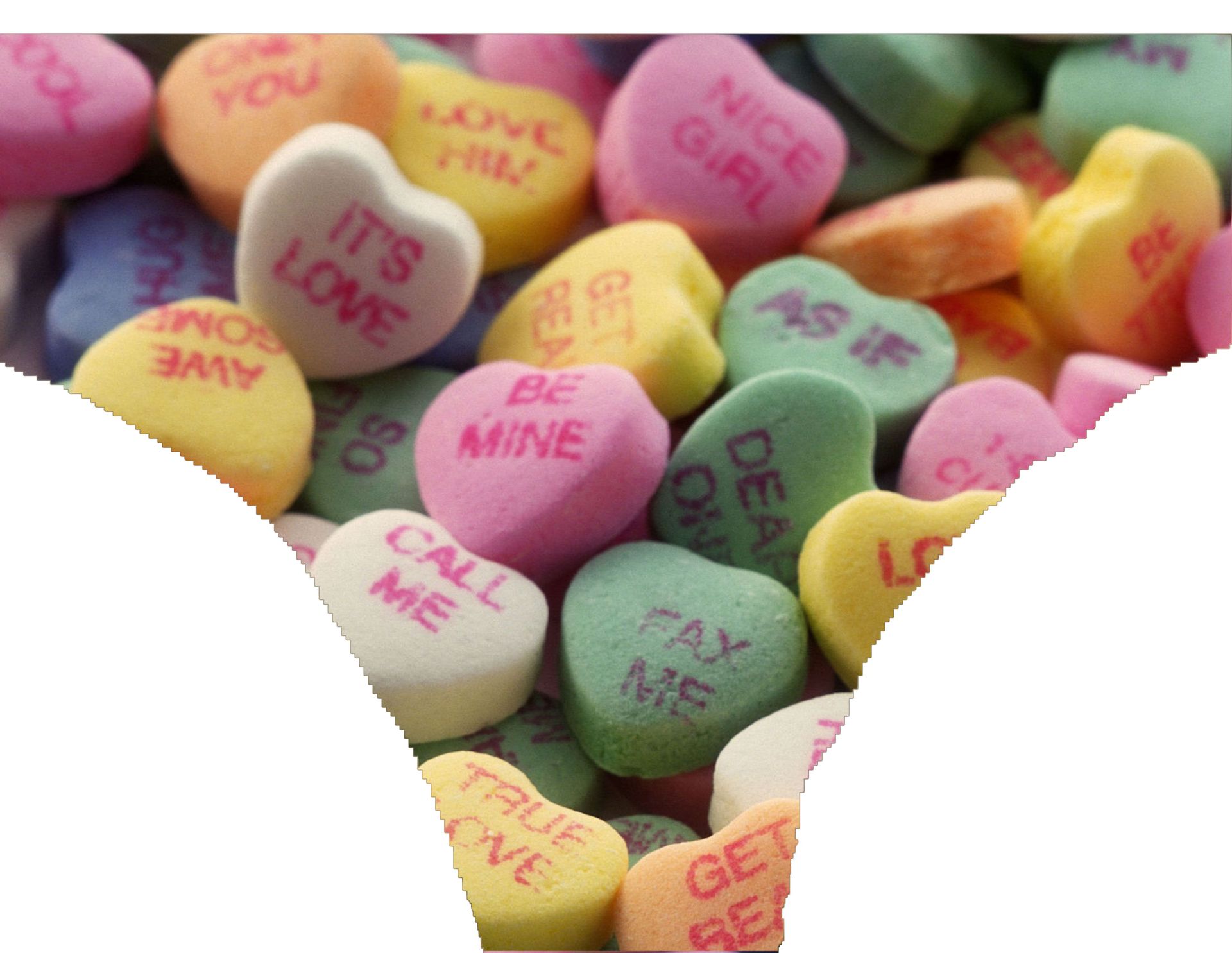 a pile of heart shaped candy with one saying it 's love