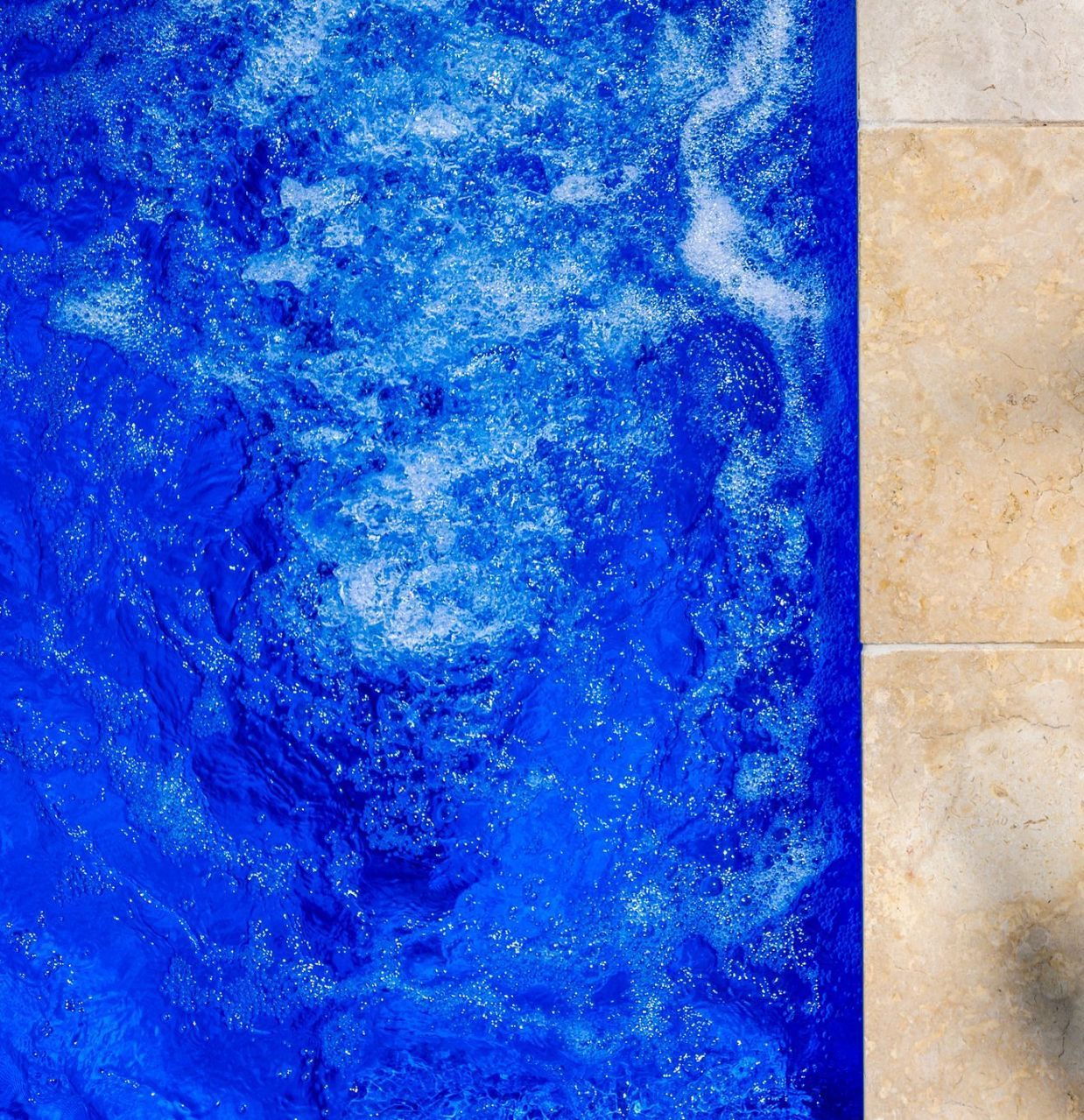 A Close Up Of A Swimming Pool With Brown Tiles And Water — Swimming Pool in Newcastle, NSW