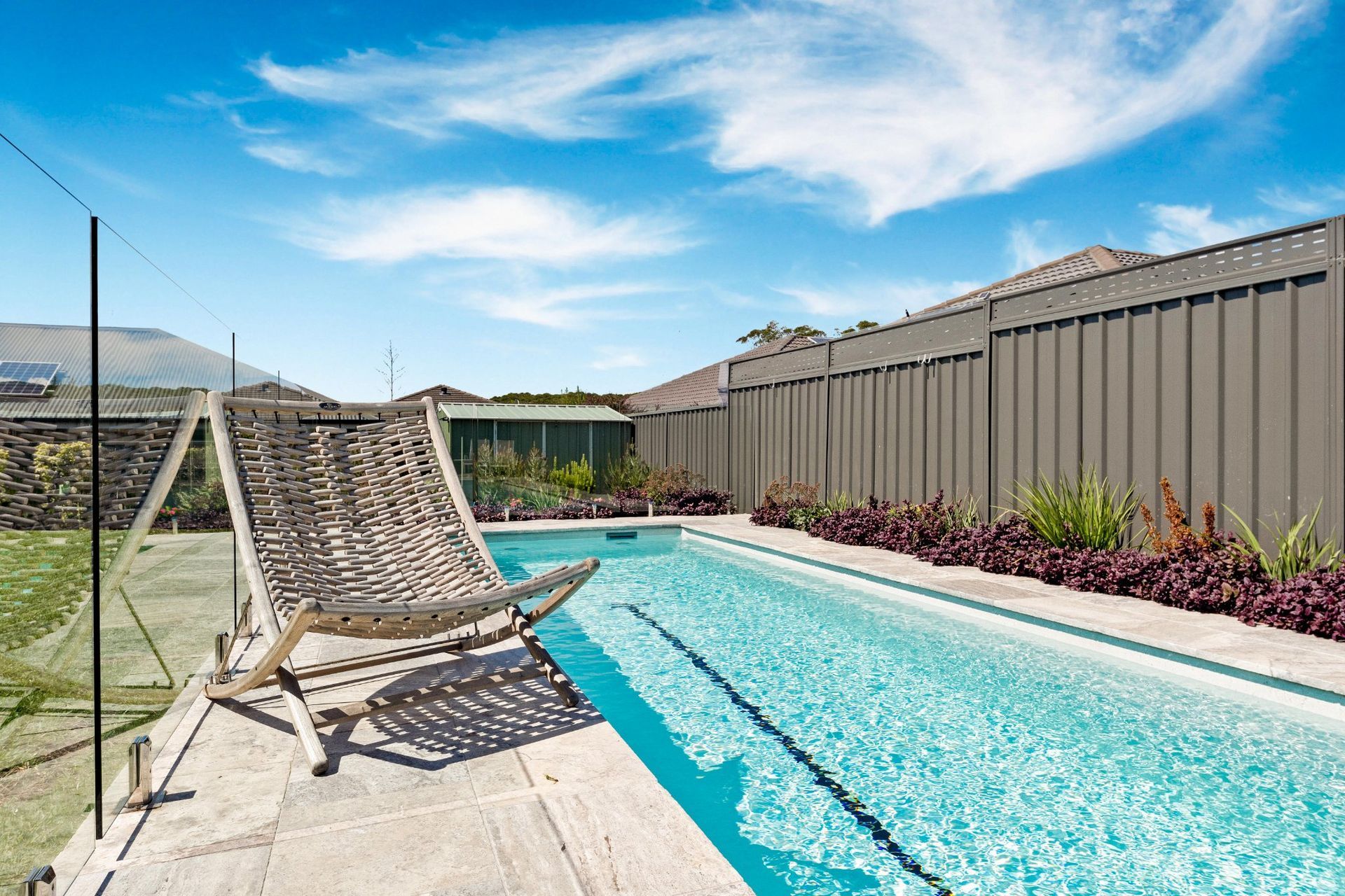 Pool Side Chair Next to Swimming Pool — Pool Installation in Newcastle, NSW