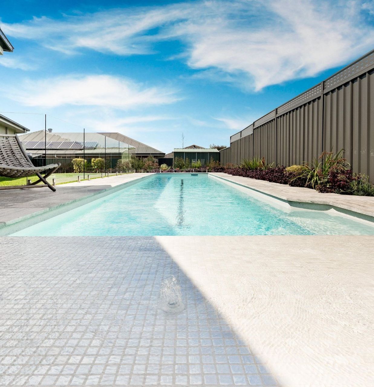 A Large Swimming Pool Surrounded By Plants — Swimming Pool in Scone, NSW
