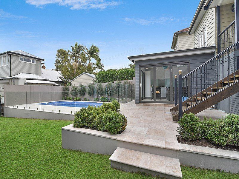 A House With A Swimming Pool And Stairs Leading Up To It — Pool Installation in Newcastle, NSW