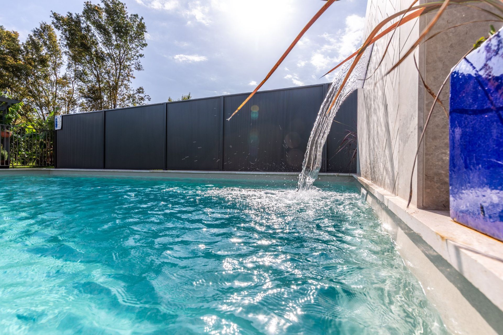 Inviting Swimming Pool with Stylish Waterfall — Swimming Pool in Newcastle, NSW