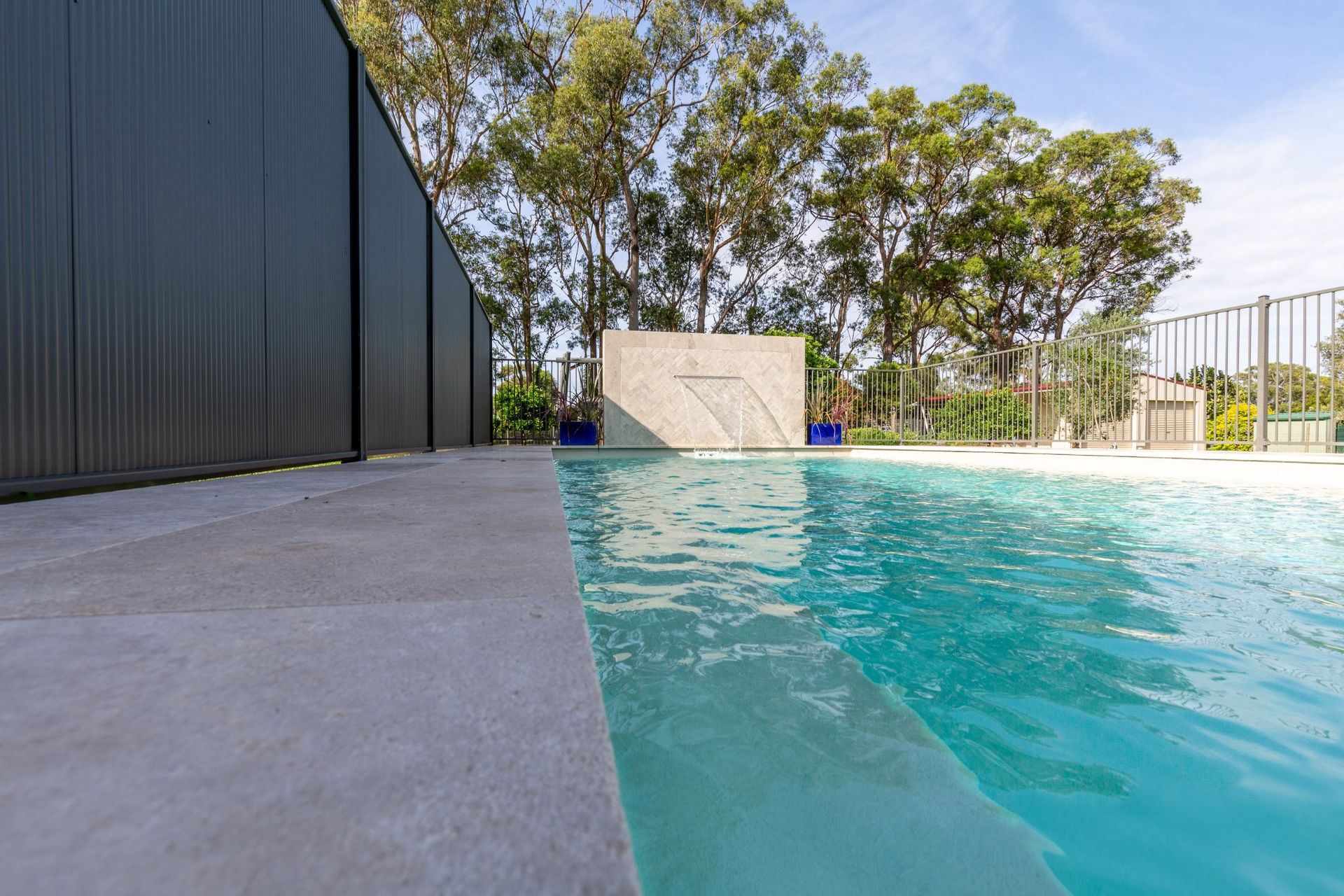 A Swimming Pool With A Waterfall — Swimming Pool in Hunter Valley, NSW
