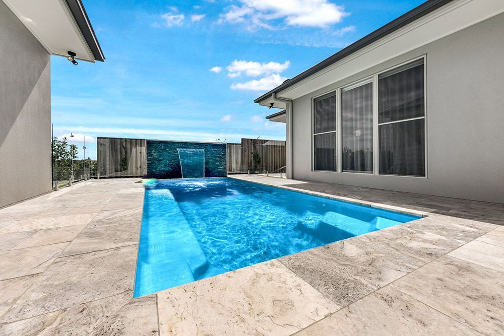Spacious Backyard Features a Large Fibreglass Swimming Pool — Pool Installation in Newcastle, NSW