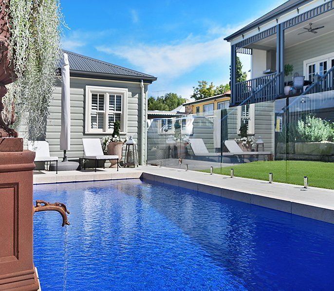 A Swimming Pool With Blue Water And A Tiled Edge — Swimming Pool in Port Stephens, NSW