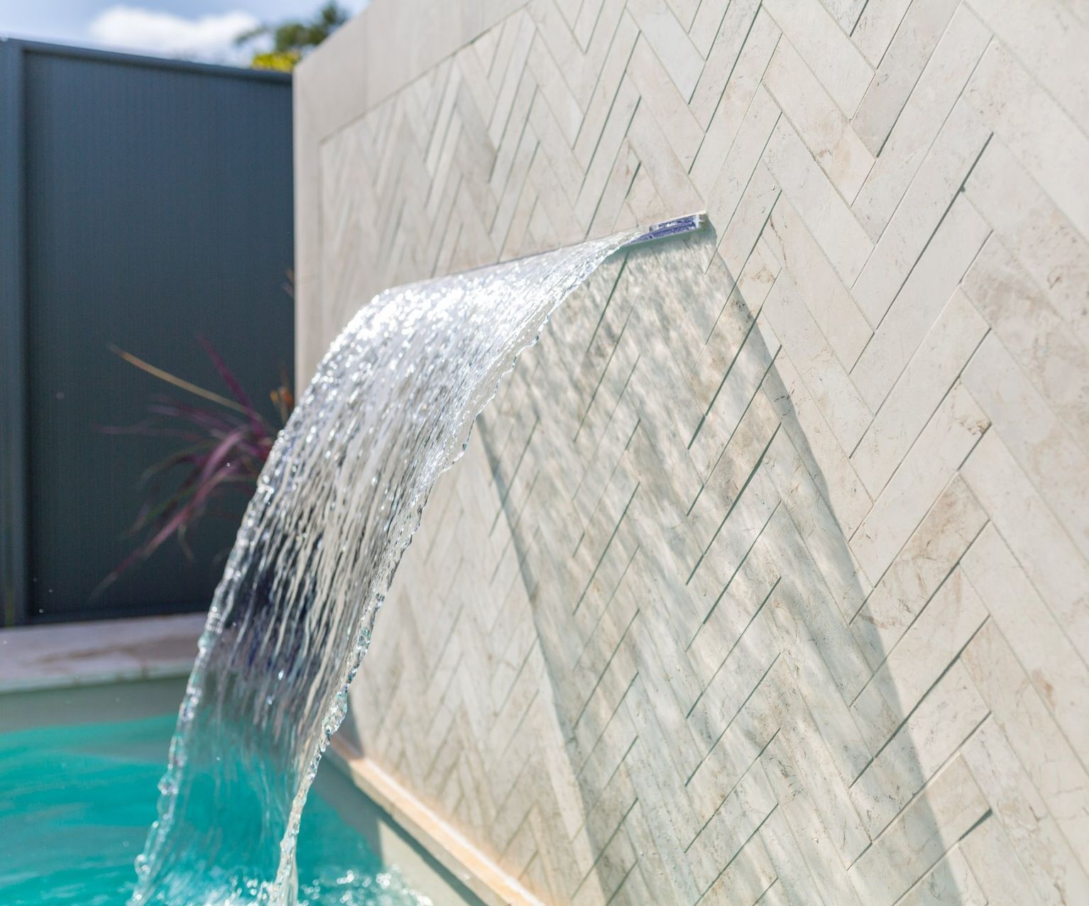 A Waterfall Next To The Pool — Swimming Pool in Maitland, NSW