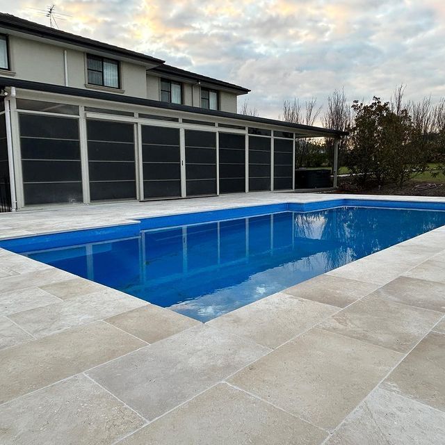A Swimming Pool With A Big House In The Background — Swimming Pool in Newcastle, NSW