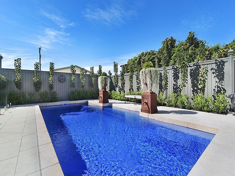 A Patio With A Gazebo , Grill , Chairs And A Swimming Pool — Swimming Pool in Lake Macquarie, NSW