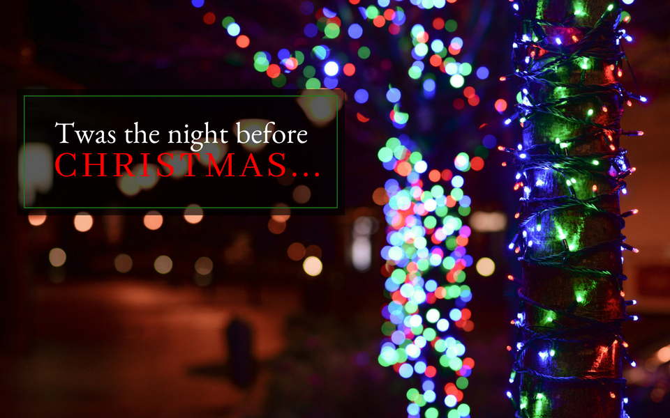 Festive holiday lights and a “Twas the night before Christmas…” sign at night