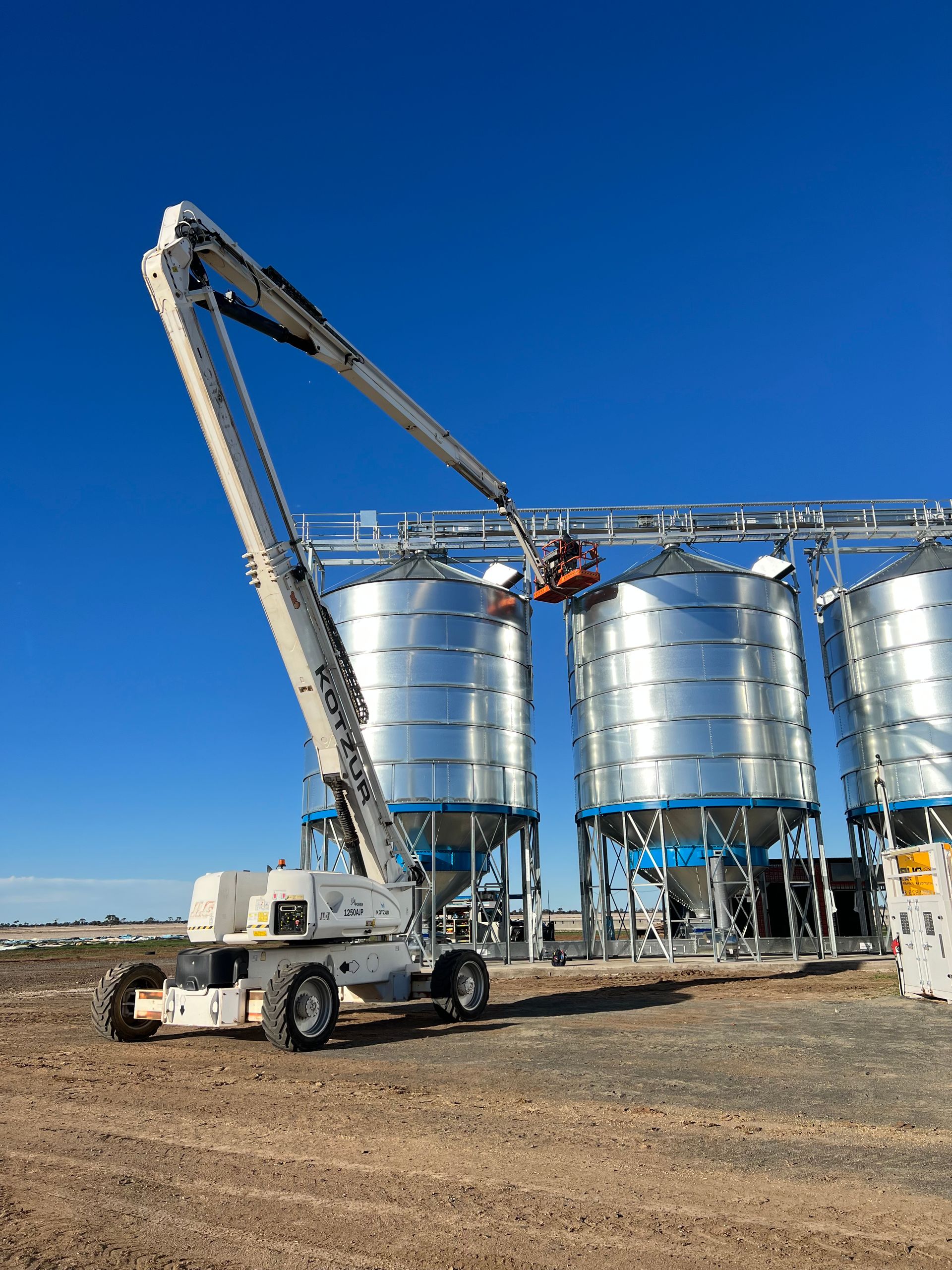 Electrical Work Being Done From Cherry Picker on Silos— Rohr Electrical In Dubbo NSW