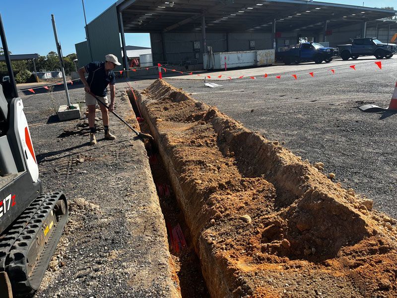Man Digging For Laying The Electrical Wiring Underground — Rohr Electrical In Dubbo NSW