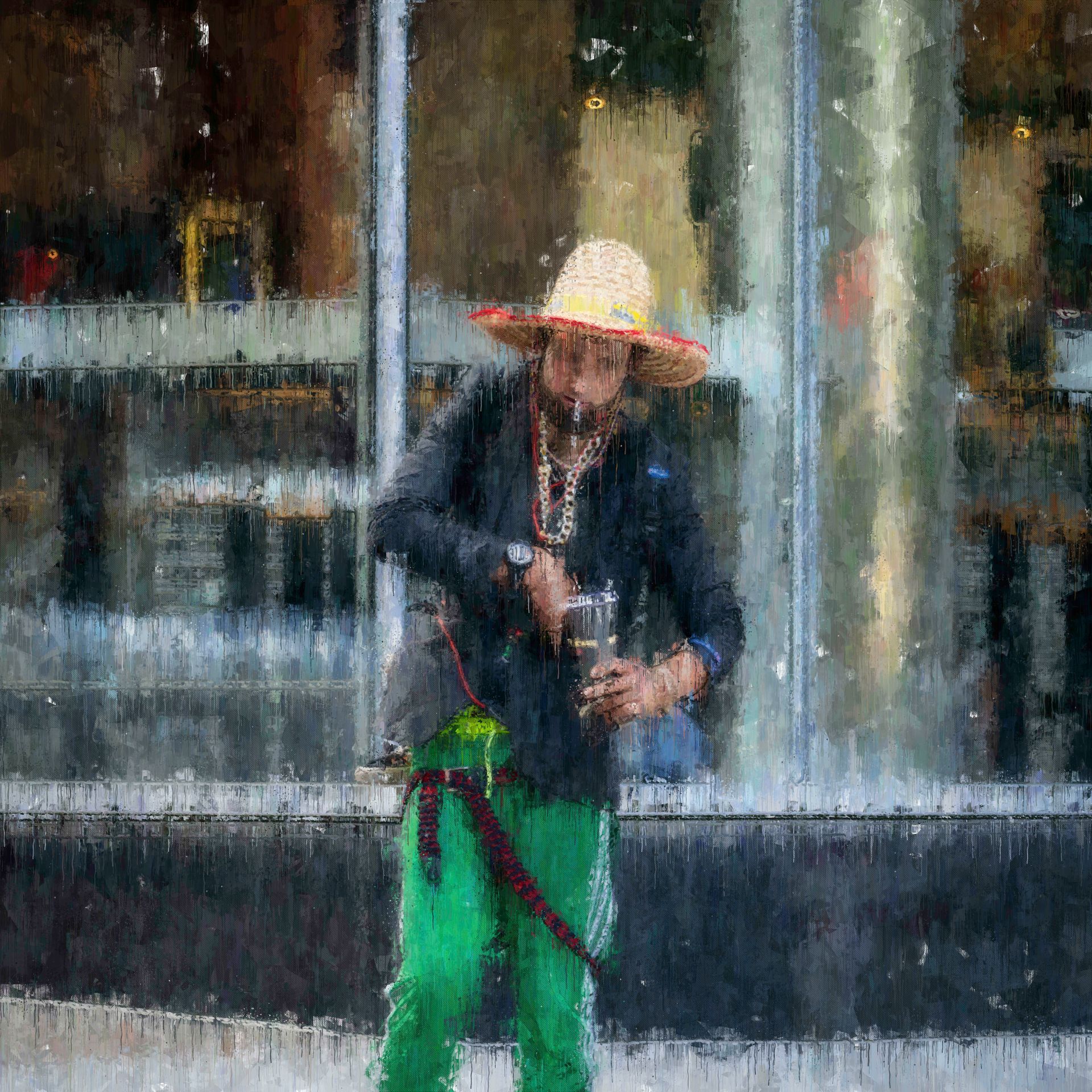 Man in straw hat and green pants holds a container, standing outside a building.