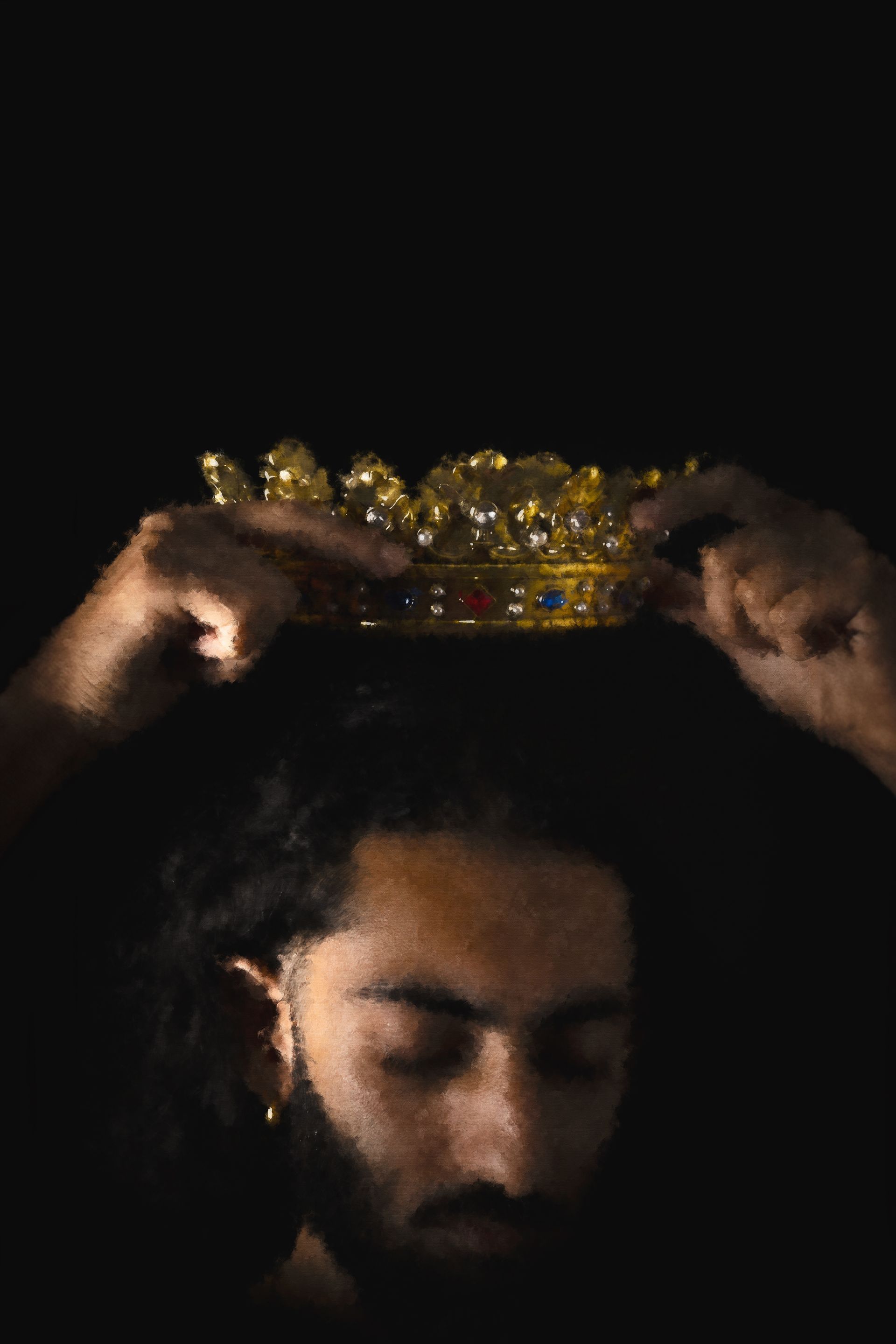 Hands placing a golden crown on a person's head, eyes closed, against a black background.