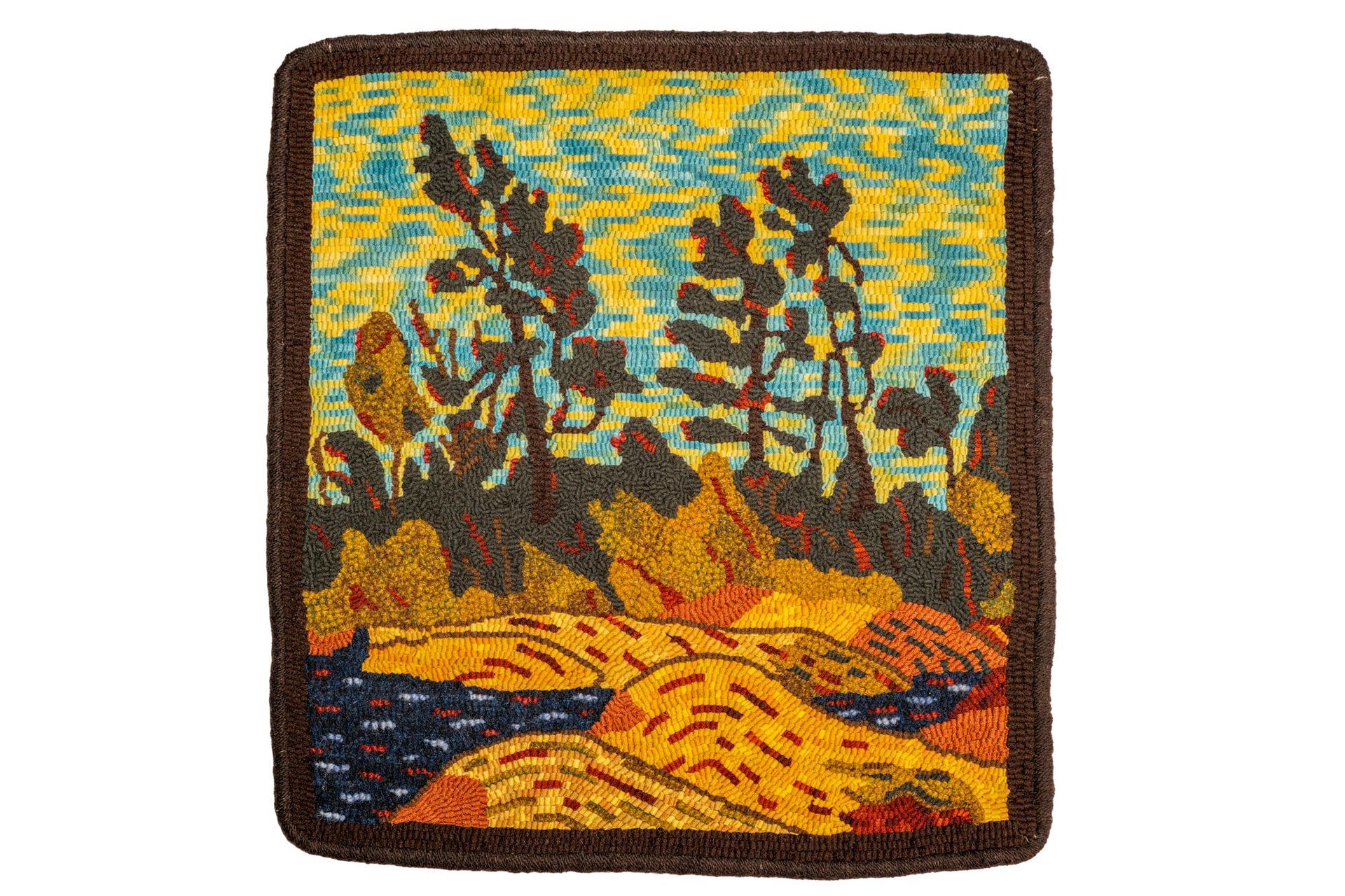 A landscape rug depicts silhouetted trees against a yellow and blue sky, with a shoreline below.