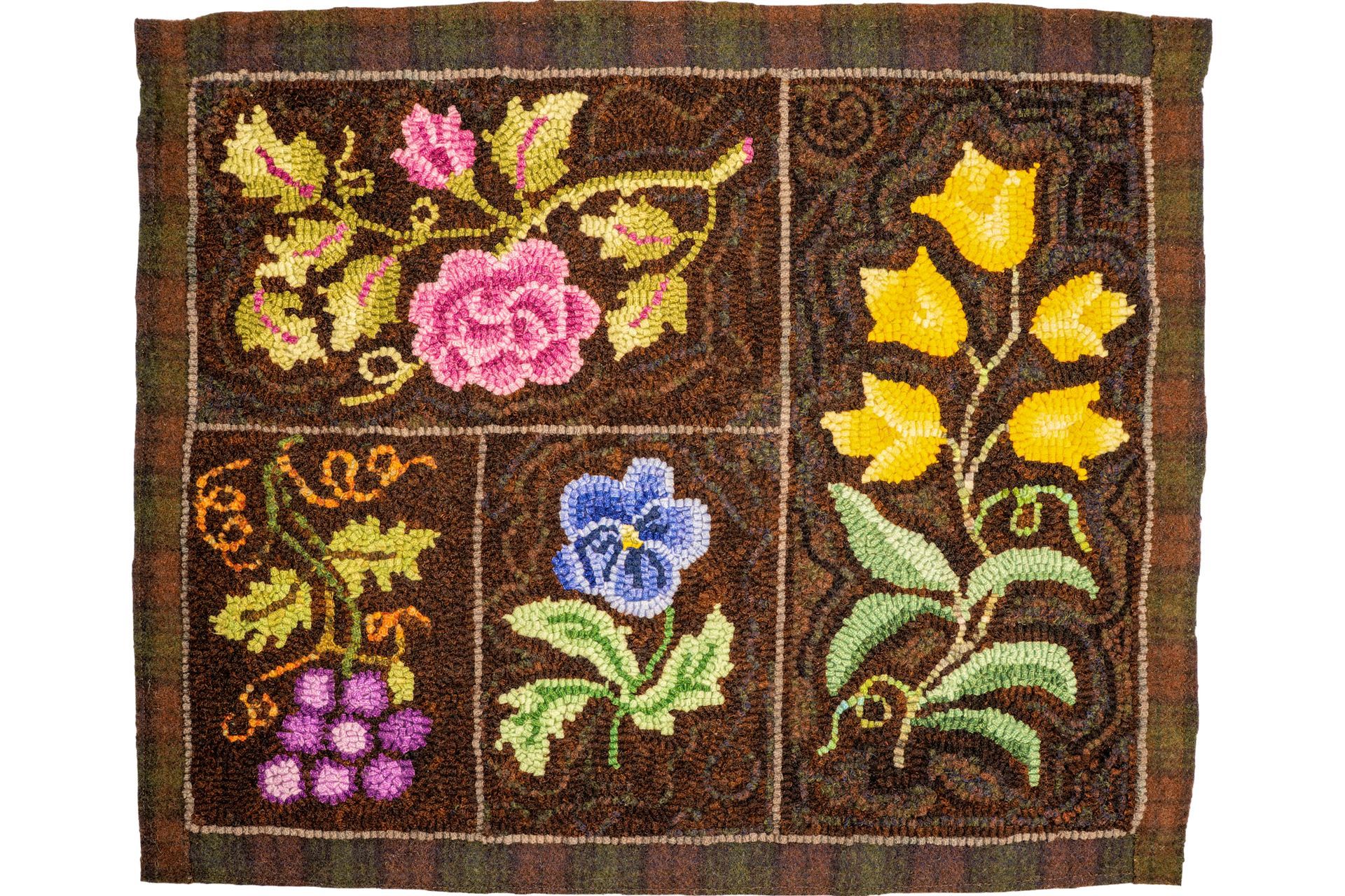 Needlepoint rug with floral designs in brown, pink, yellow, blue, and green.