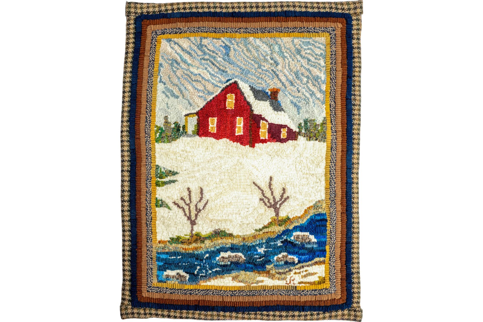 Rug with a red house in a snowy landscape, blue stream, brown border, and light blue sky.