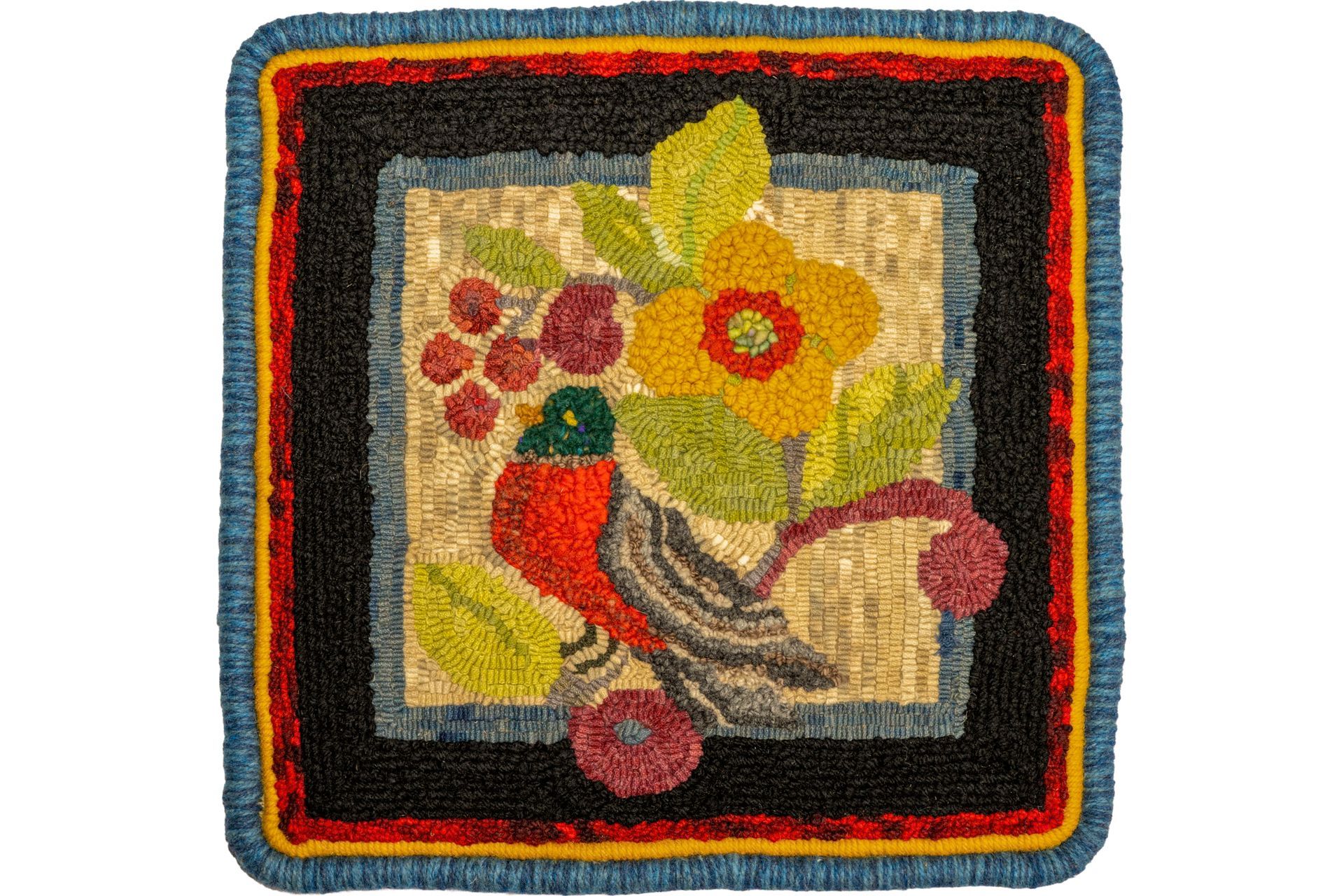 Rug with a bird and flowers in a square design, featuring red, yellow, and green colors.