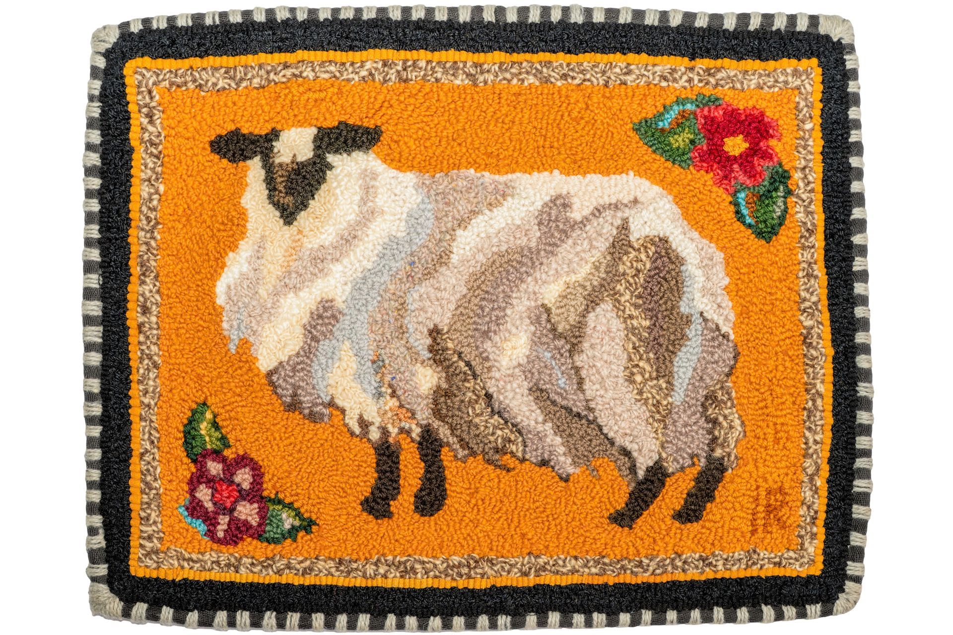 Woolly sheep rug on orange background with flowers and black border.