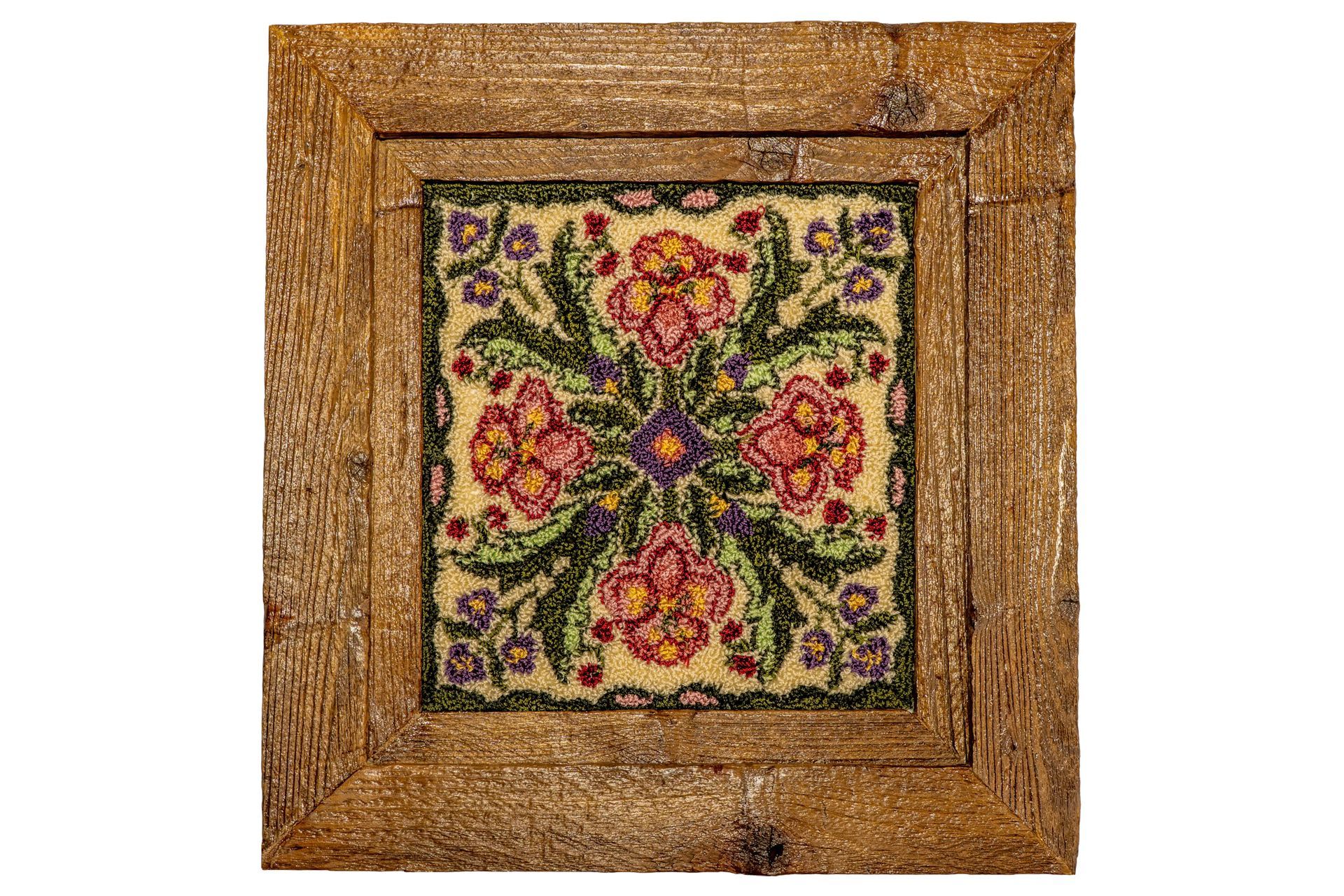 Square rug with floral pattern, set in a wooden frame.