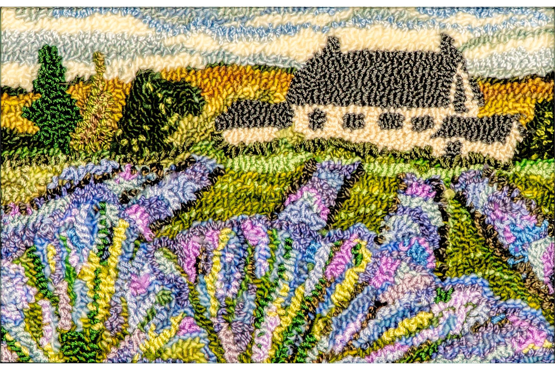 Lavender field with a cottage, depicting rows of purple flowers and a white building with a black roof.