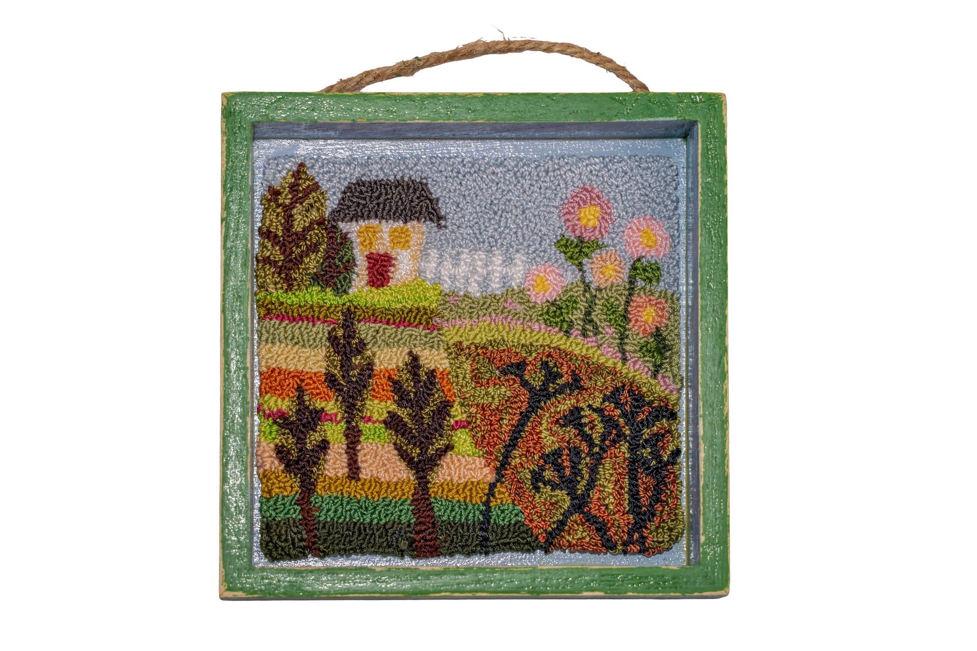 Beaded landscape art: a house, flowers, and trees in a green-framed square.
