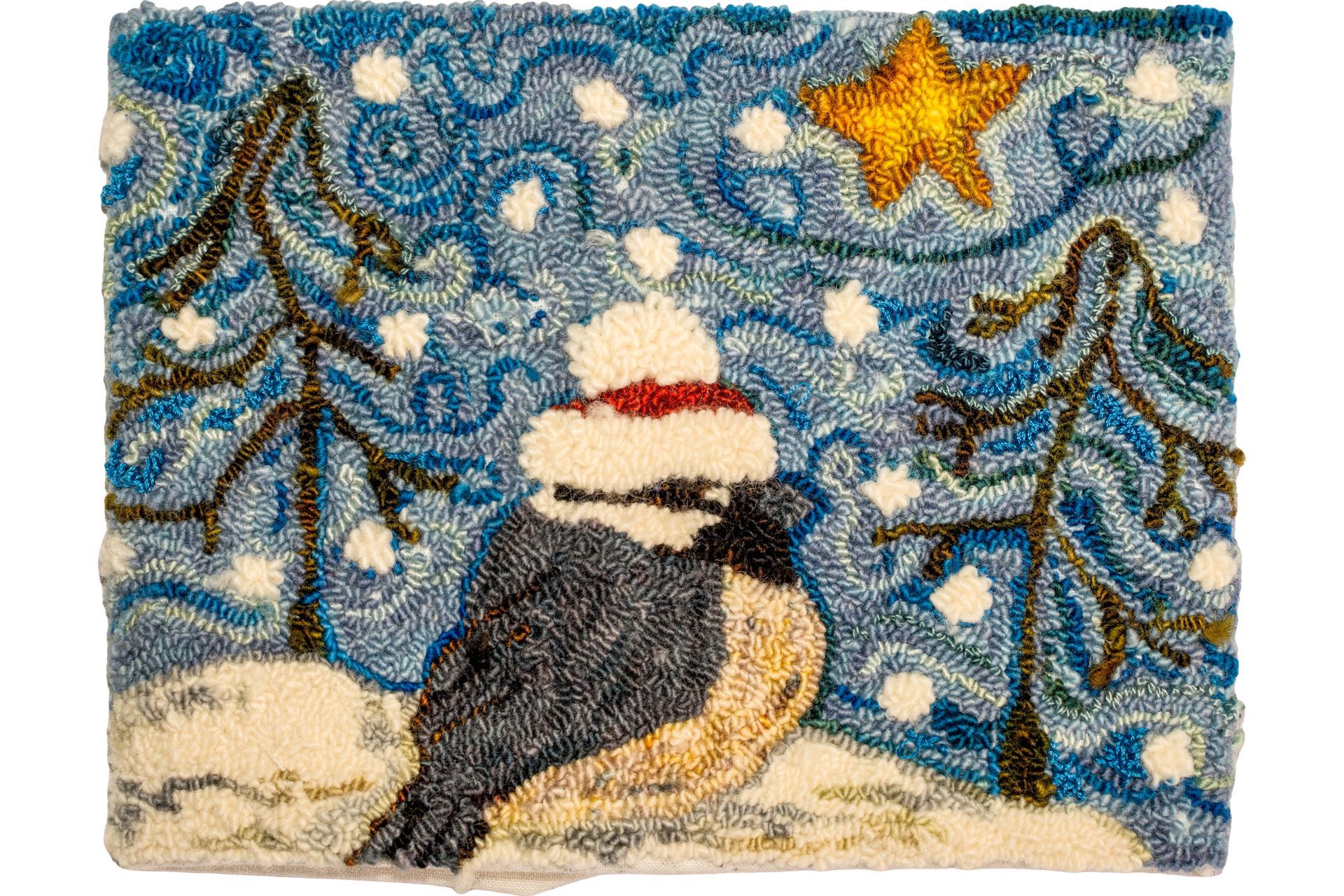 Chickadee wearing a red and white hat in snowy scene with star and fir trees.