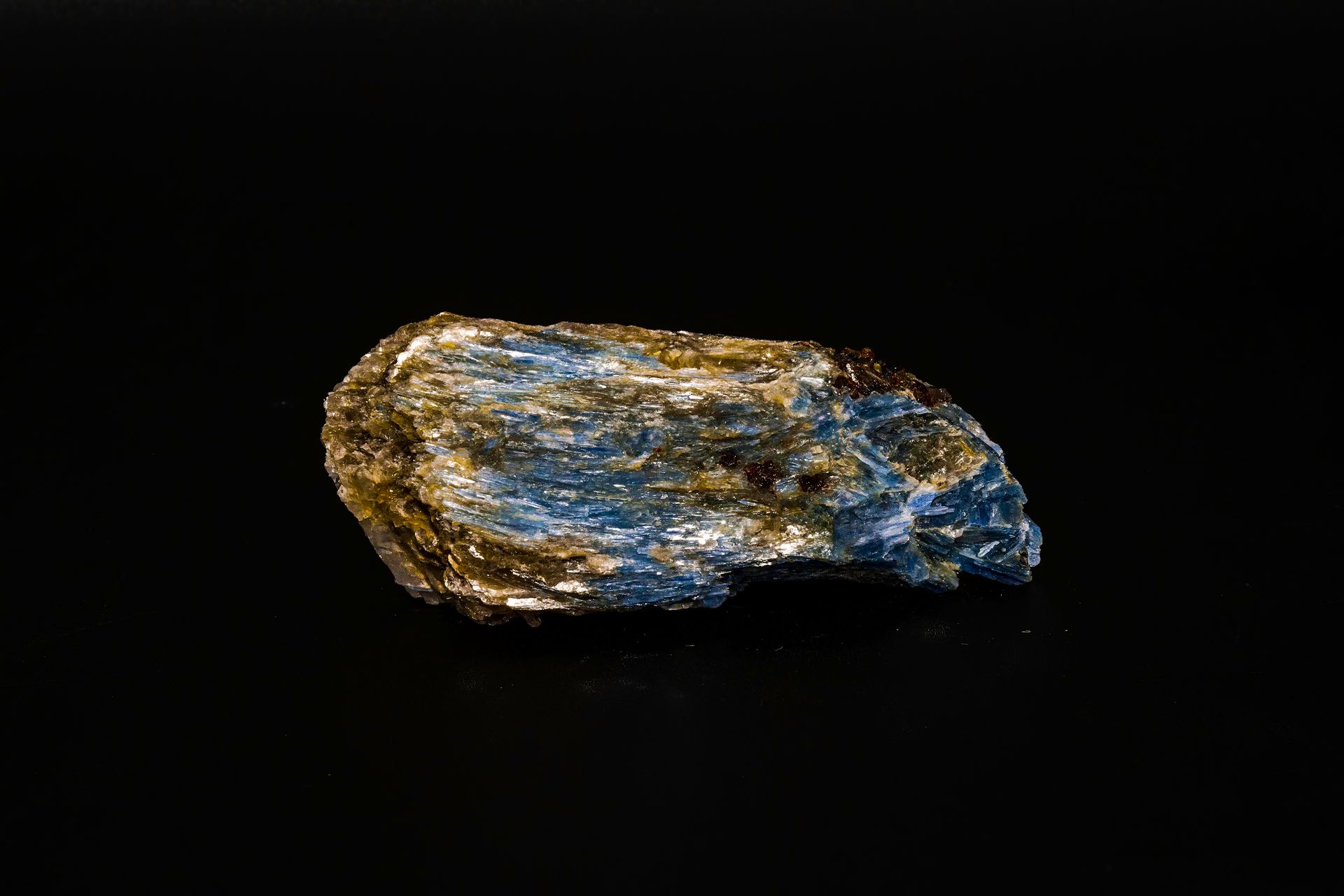 Blue and gold mineral specimen against a black background.
