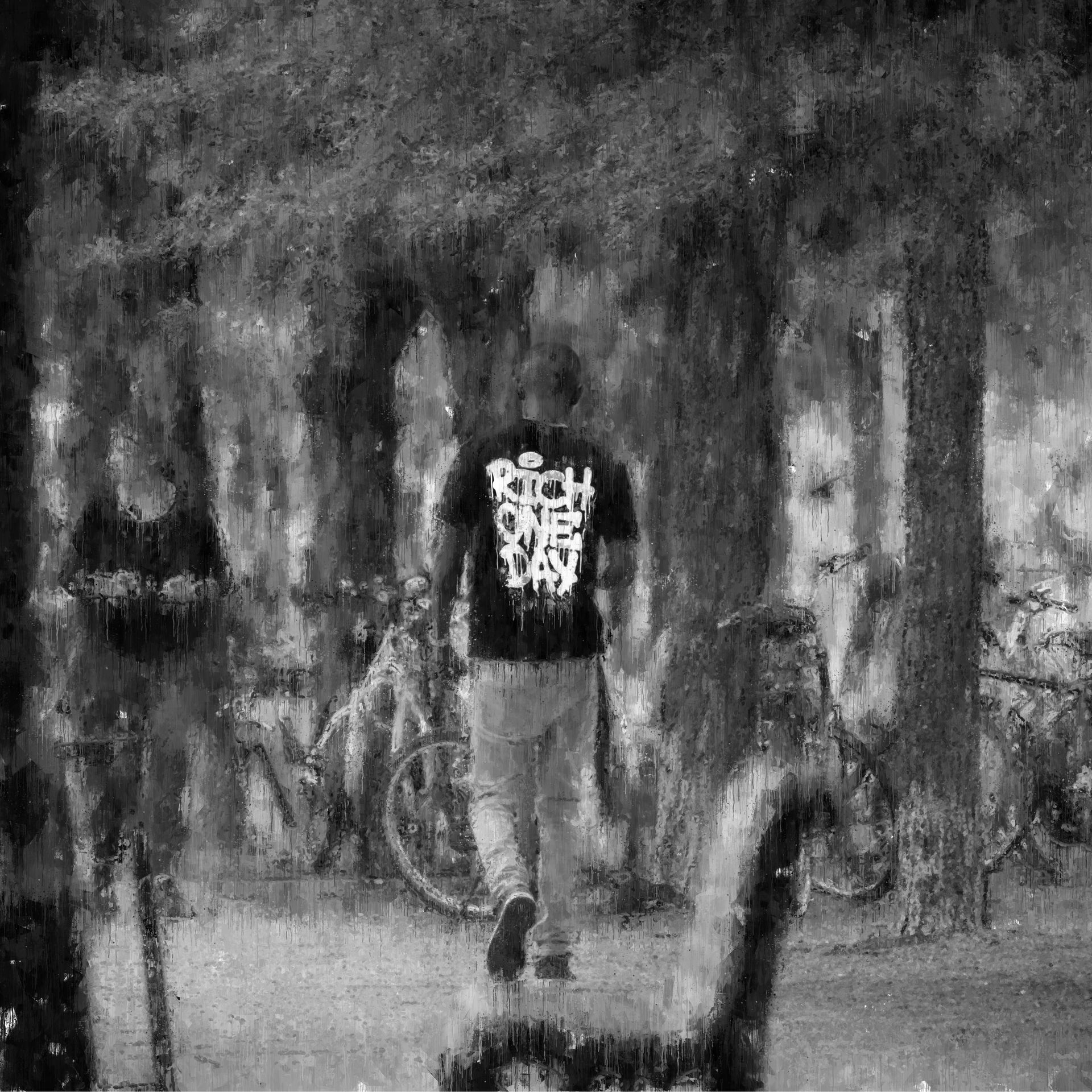 Man walking in park with bicycles. Black and white, trees in the background.